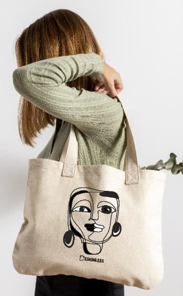 حقيبة توت من قماش الكانفاس القطني برسمة وجه خطي من Designless